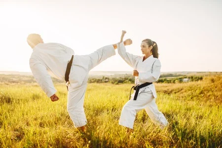 121627881-male-and-female-karate-masters-fight-in-field